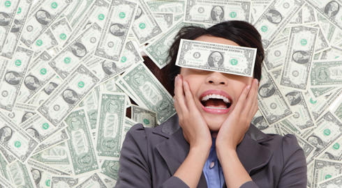 Young business woman excited lying on money background and money cover her eyes, asian beauty model